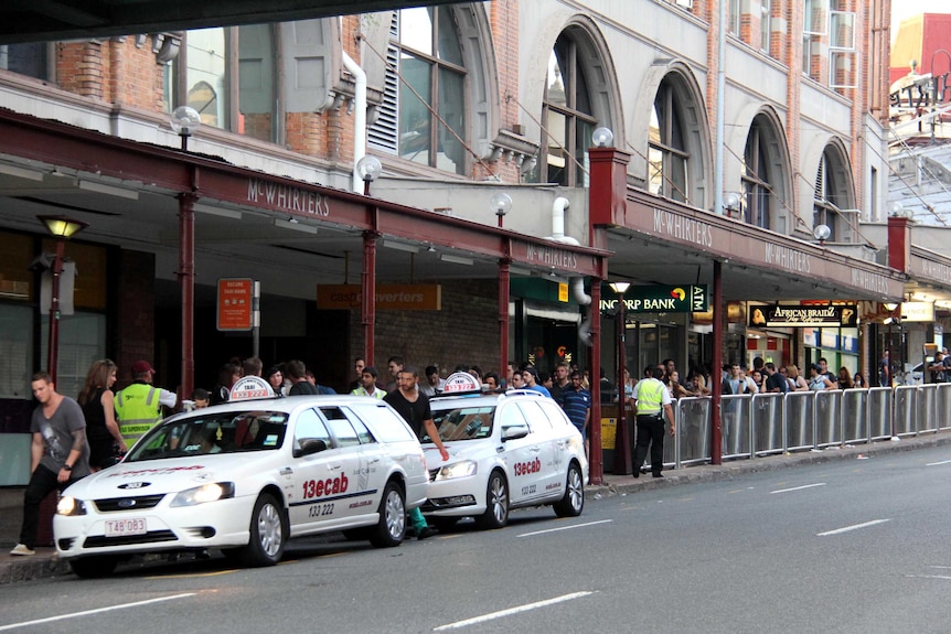 People queue for taxis in Brisbane's Fortitude Valley.