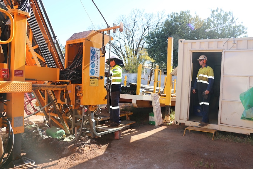 Two workers drill for gold in Kalgoorlie.
