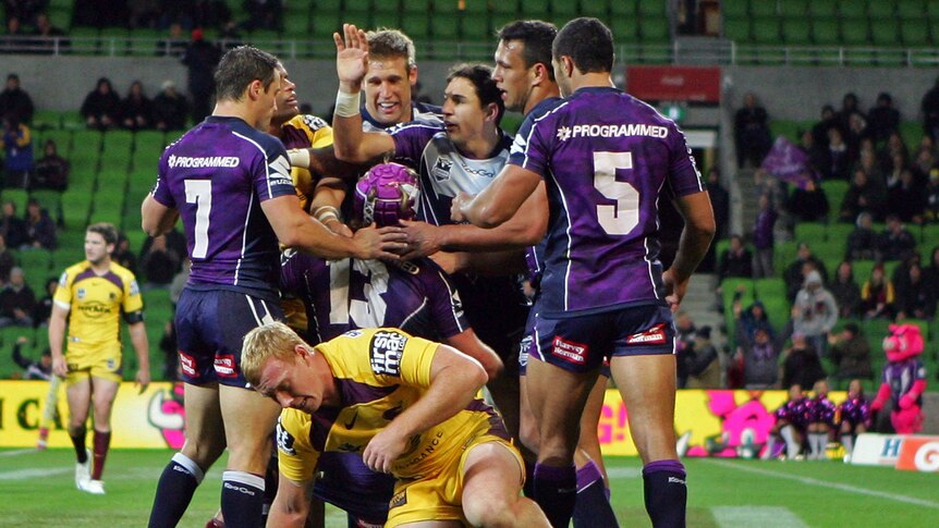 Storm surge ... Melbourne players celebrate milestone man Todd Lowrie's try.