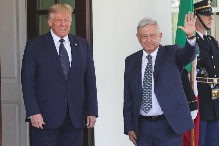 US President Donald Trump and Mexican President Andres Manuel Lopez Obrador smile and wave at people outside the White House