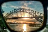 The Sydney Harbour Bridge seen through a pair of sunglasses.