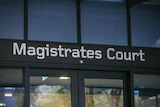 A close-up photo of a sign saying Magistrates Court.