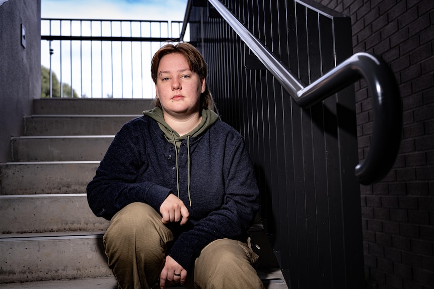 A person sitting in a stairwell