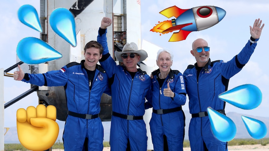 Four people standing in front of a rocket, wearing blue space jump suits, smiling waving and looking proud