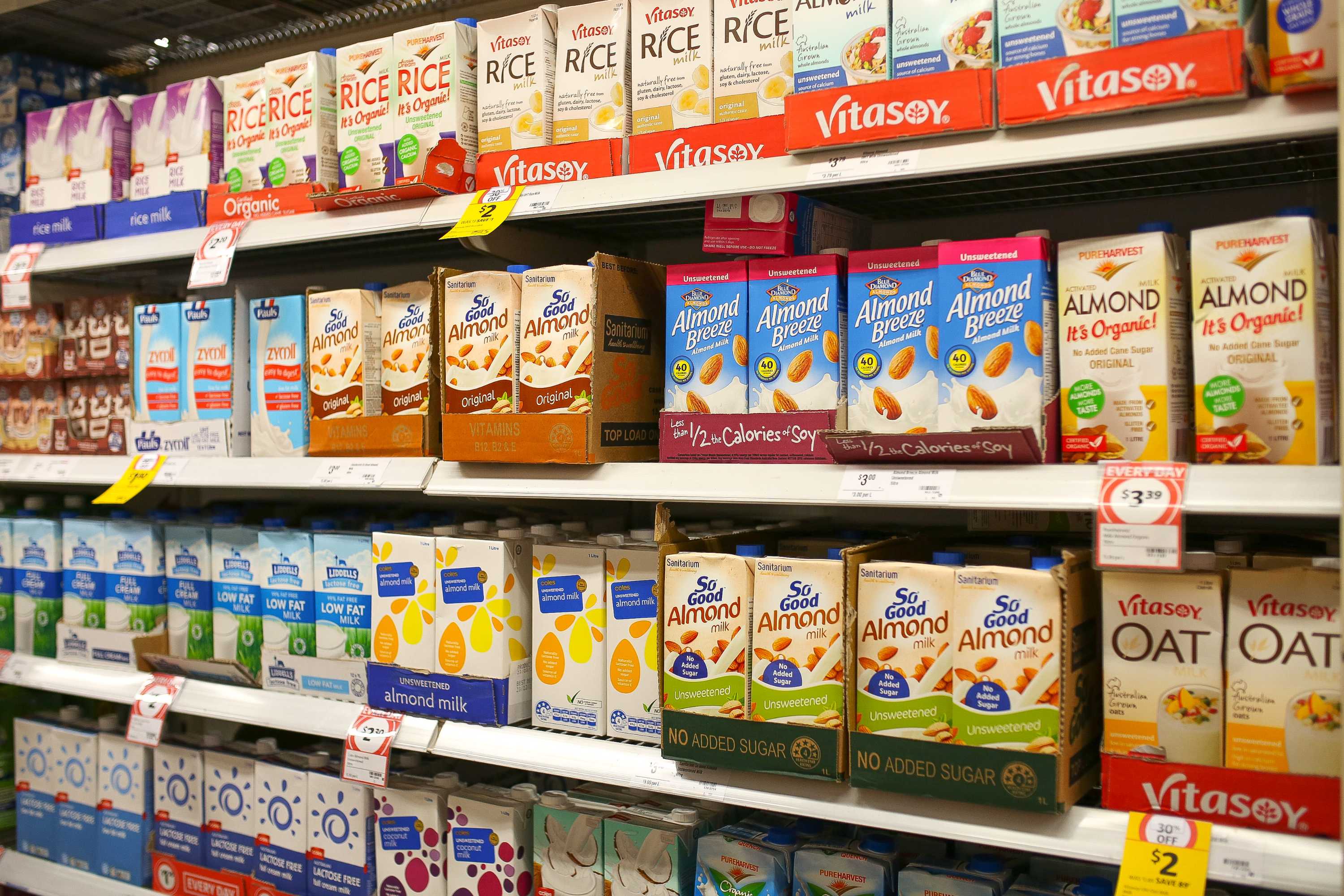 Supermarket shelf of rice, soy and almond boxes.
