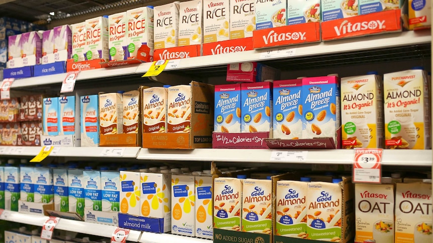 Supermarket shelf of rice, soy and almond boxes.