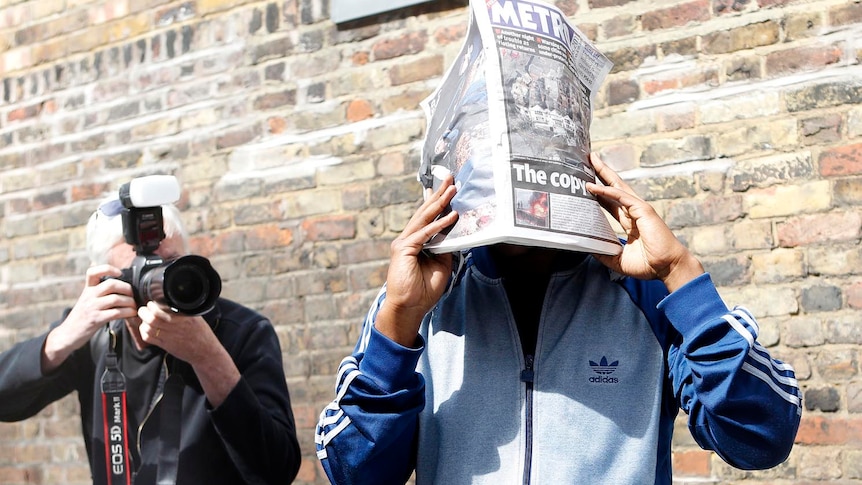 Looter attempts to shield his face as he leaves Highbury Magistrates court