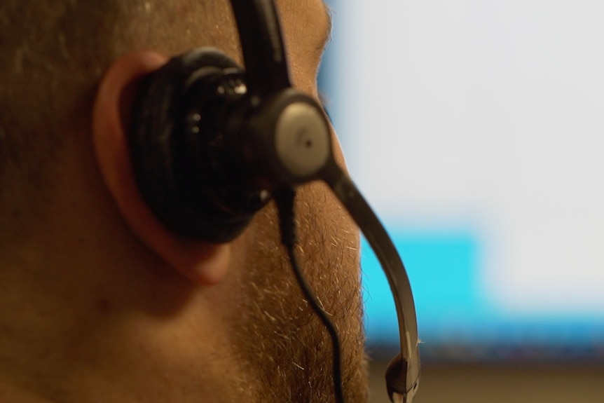 A man wearing a telephone headset.