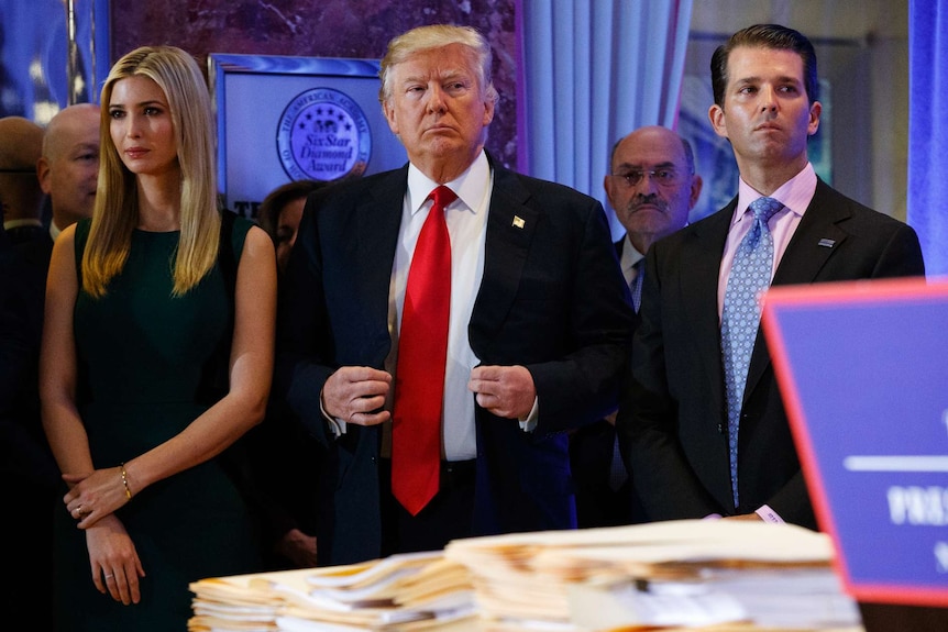 Donald Trump stands next to Allen Weisselberg, Ivanka Trump and Donald Trump Jr.