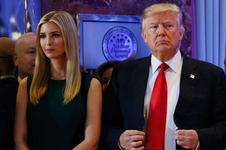 Donald Trump stands next to his daughter Ivanka Trump