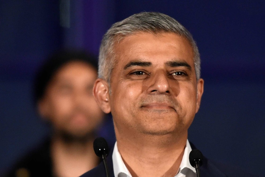 Sadiq Khan at the microphone smiling