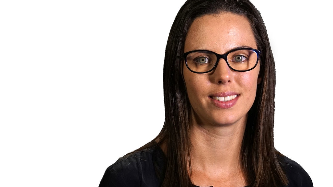 A headshot of a woman with long dark hair and glasses.