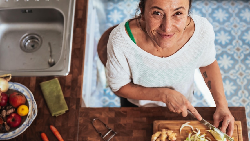 Woman chopping vegetables in the kitchen.