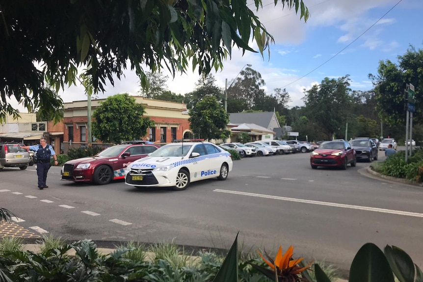 A police vehicle near other vehicles in a car park in Bellingen