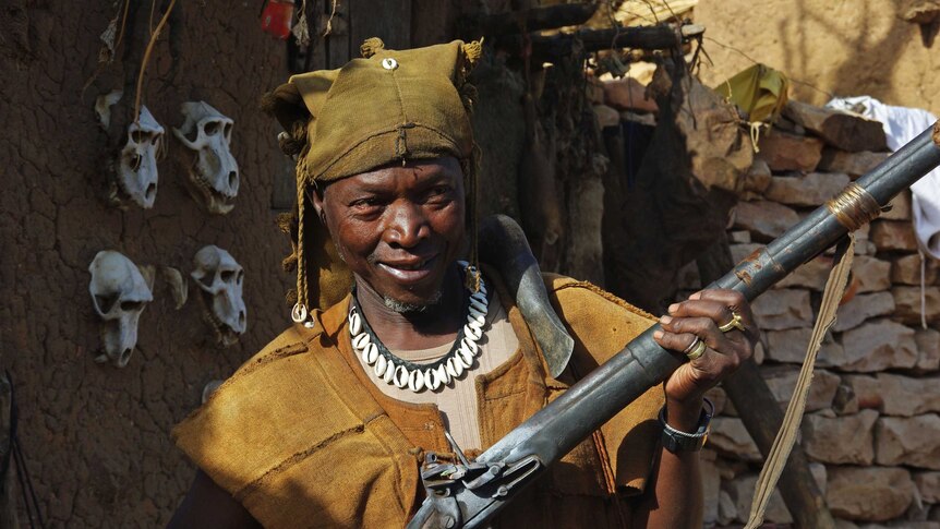 Hunter in Dogon region, Mali, holding a flintlock rifle.