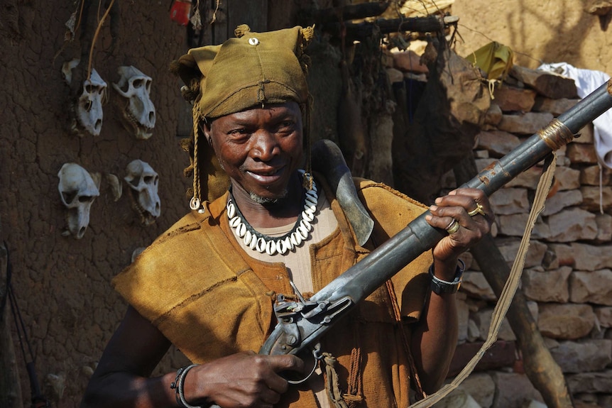 Hunter in Dogon region, Mali, holding a flintlock rifle.