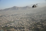 A Blackhawk helicopter flies over Kabul. 