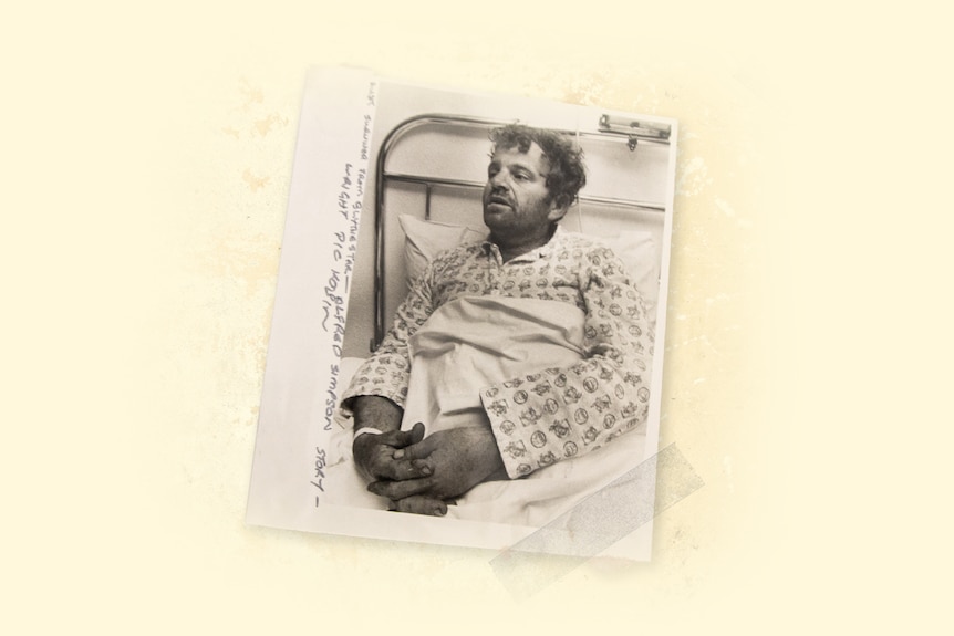 A man in pyjamas in a hospital bed.