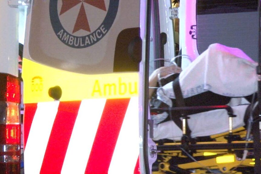 man being transported in the back of an ambulance