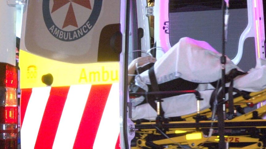 man being transported in the back of an ambulance