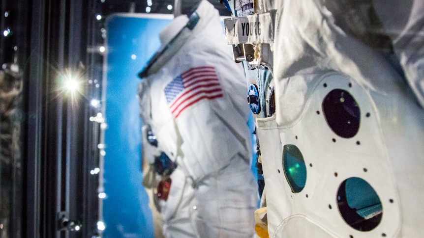 Two NASA suits equipped with safety equipment.