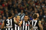 Year of the Magpies? Collingwood team-mates celebrate Alan Didak's goal.