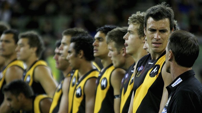 Making a stand... Richmond and Essendon both linked arms in unity against domestic violence.