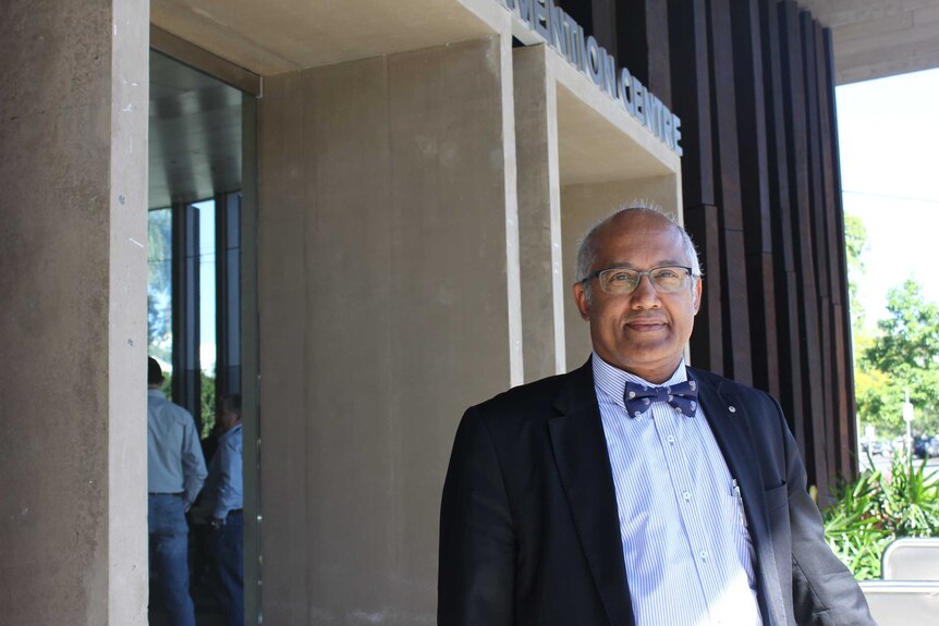 Jim Varghese standing in front of the Mackay Entertainment and Convention Centre