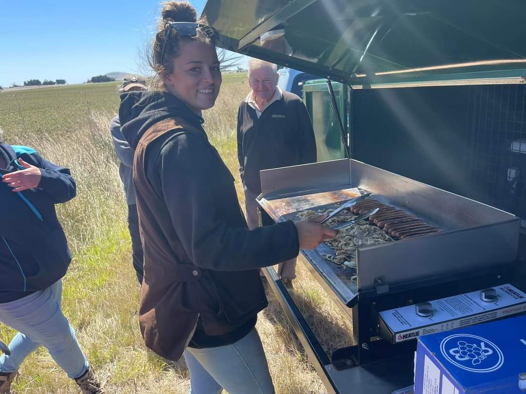 A farmer using a barbecue.