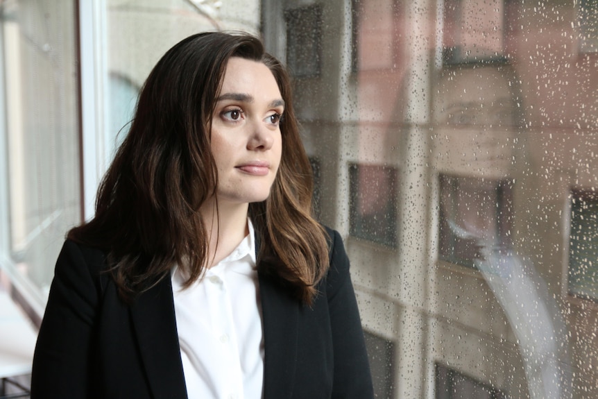 CoreLogic's head of Australian research Eliza Owen looks out of a window in an office