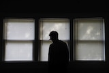A silhouette of a person in a hospital setting
