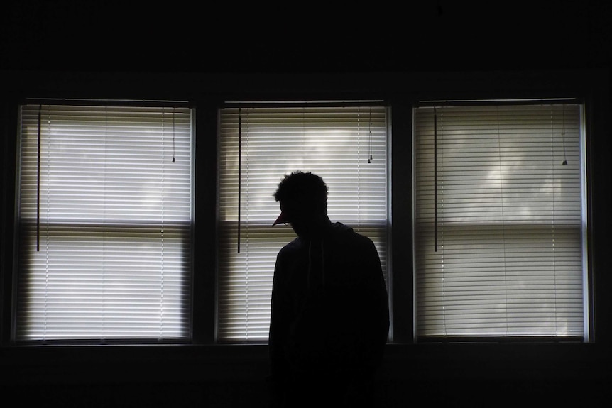A silhouette of a person in a hospital setting