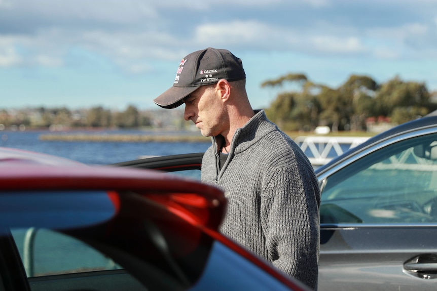 Jason Brown getting into his red car in Montrose, in Hobart's norther suburbs.