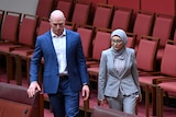 Fatima Payman walks alongside David Pocock as she crosses the floor to vote against Labor