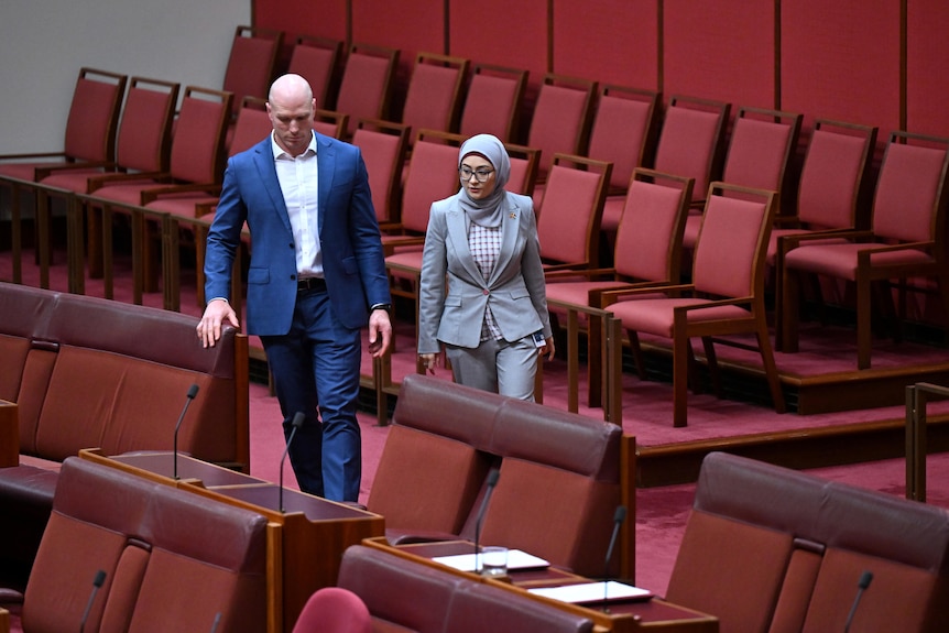 Fatima Payman walks alongside David Pocock as she crosses the floor to vote against Labor