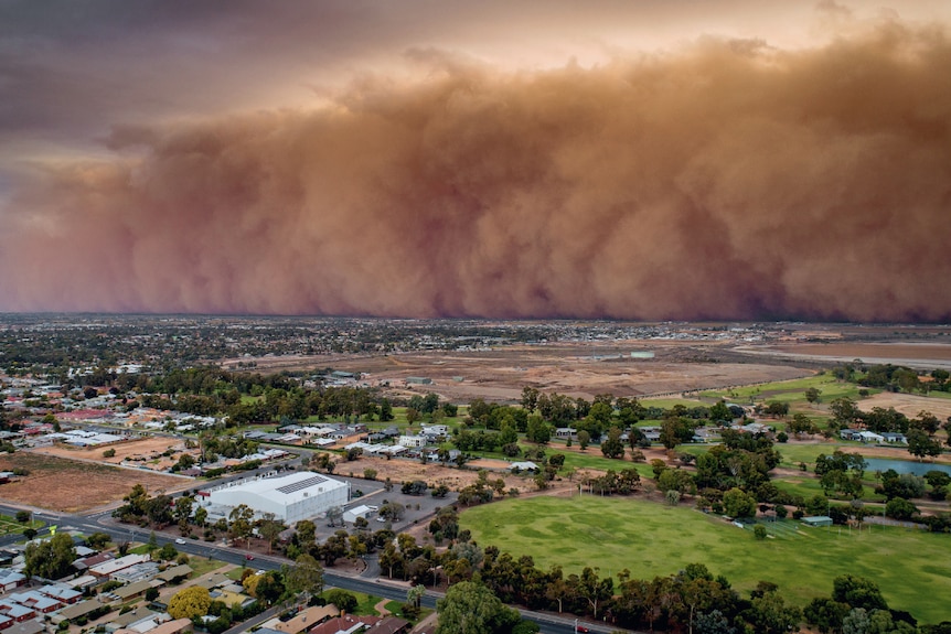 Enormous red dust rolls towards the flat Victorian city of Mildura