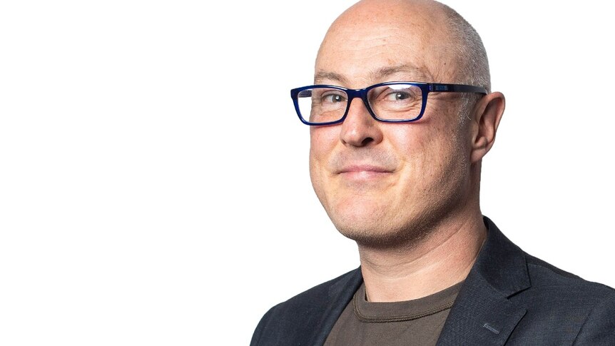 A profile image of a bald man wearing glasses.