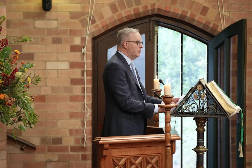 Anthony Albanese delivers a speech inside a church