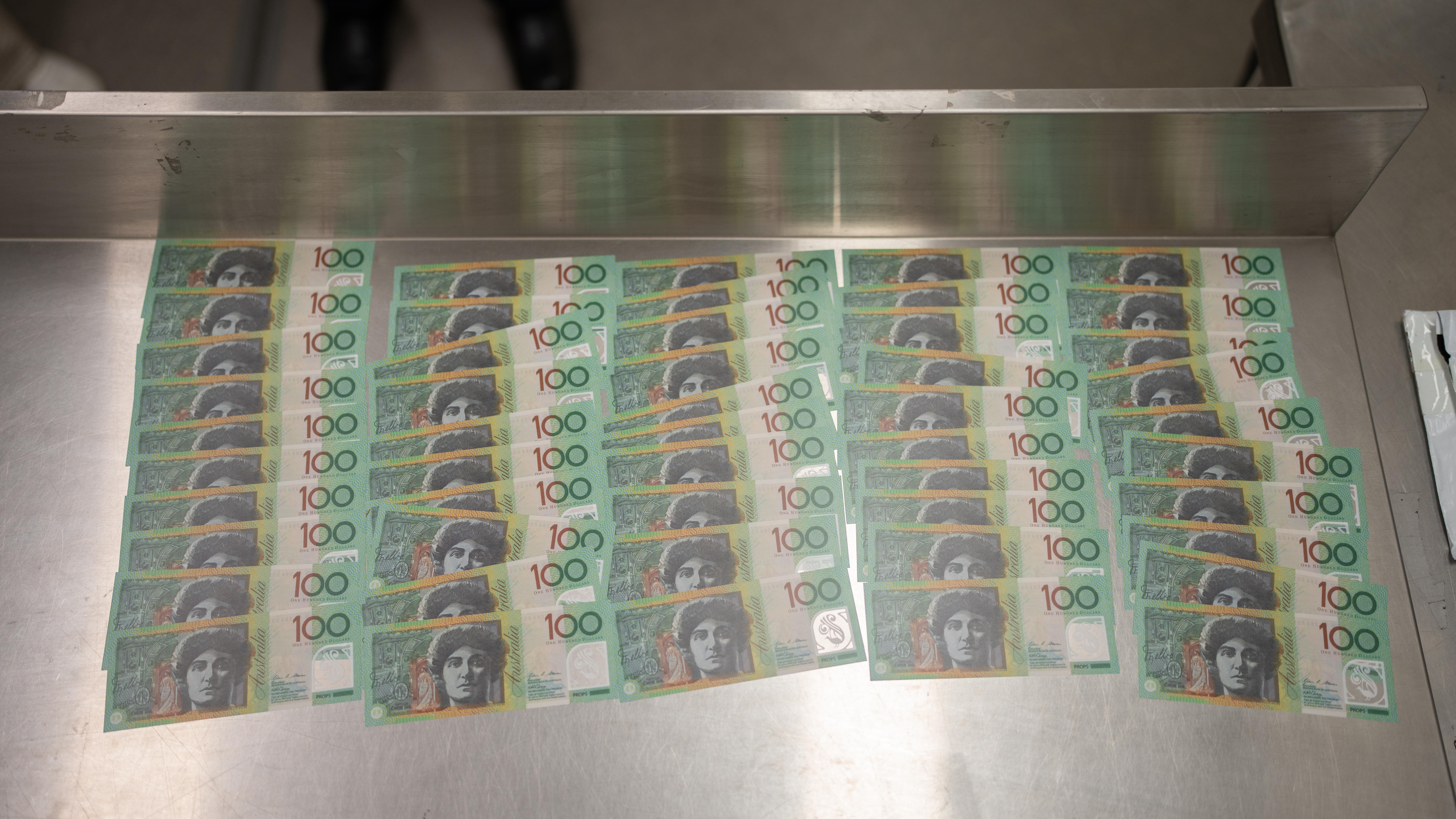 钢桌上摆放着假币。