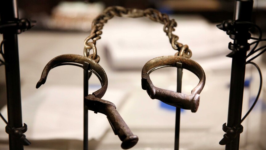 Slave shackles are seen in a display case