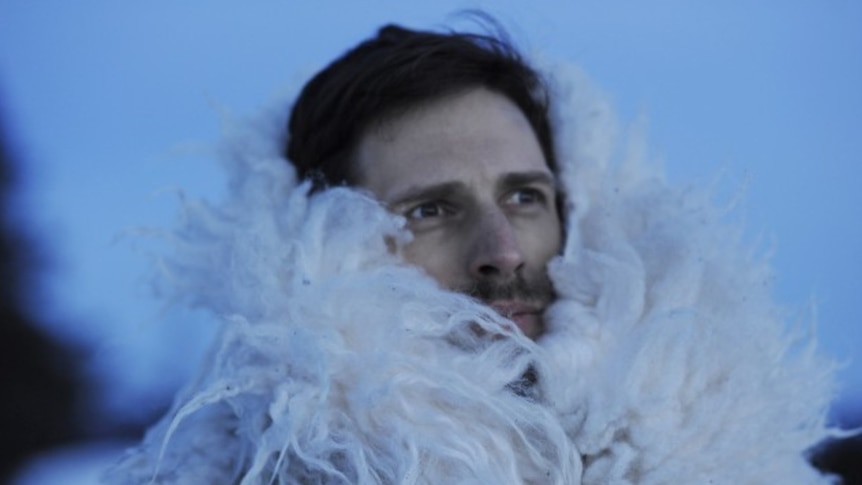 Norwegian music producer Hans-Peter Lindstrøm wraps himself in a white fluffy winter coat outside in the cold