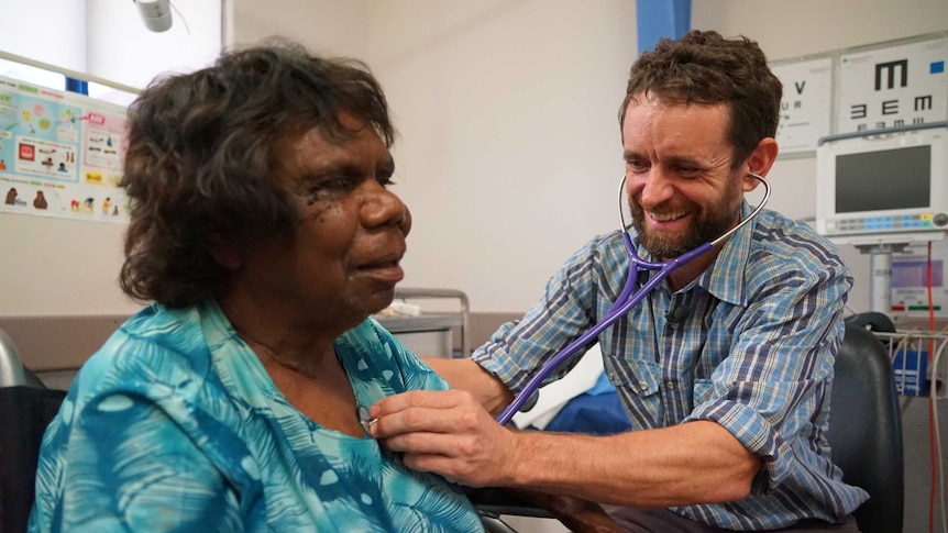 A doctor attends to a patient in a surgery.