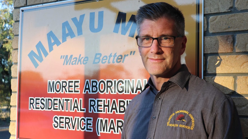 David Kelly from the Maayu Mali Residential Rehabilitation Centre in Moree stands in front of his service's sign