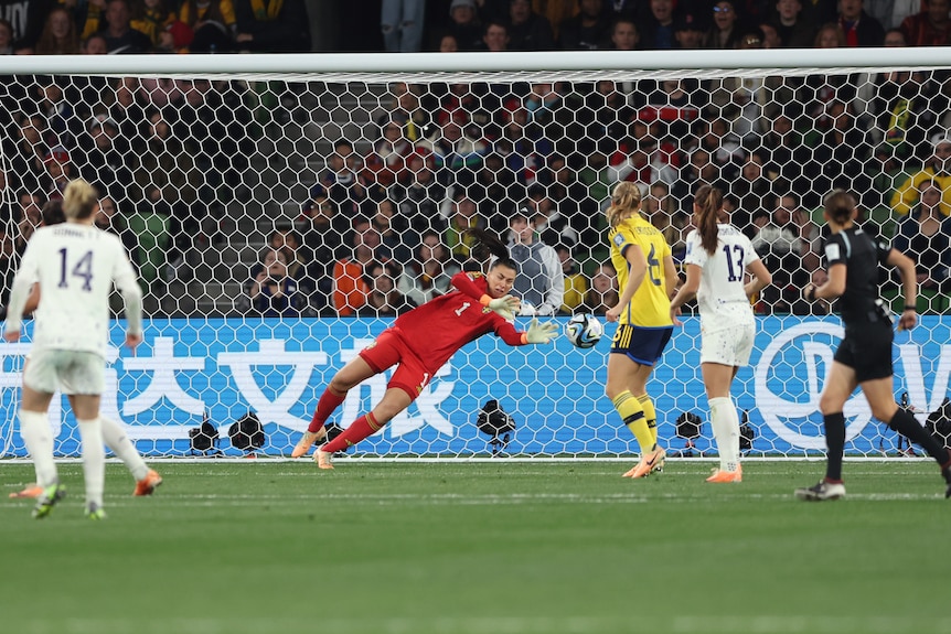 Sweden goalkeeper Zecira Musovic dives to save a ball in a FIFA Women's World Cup game against USA.