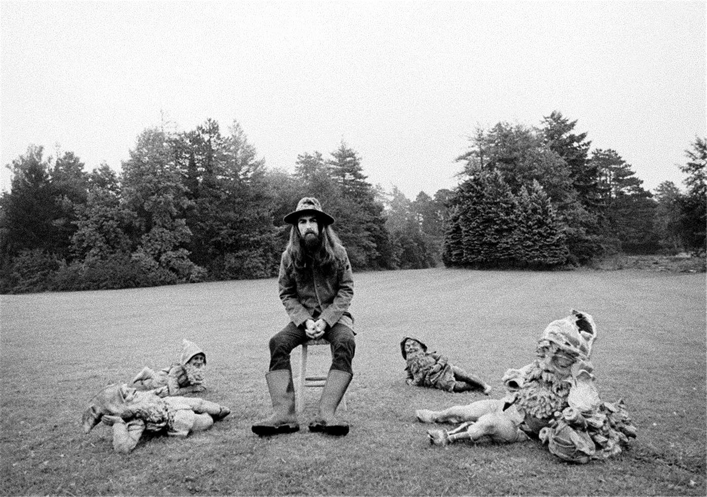Album cover of George Harrison siting on a stool surrounded by four garden gnomes.