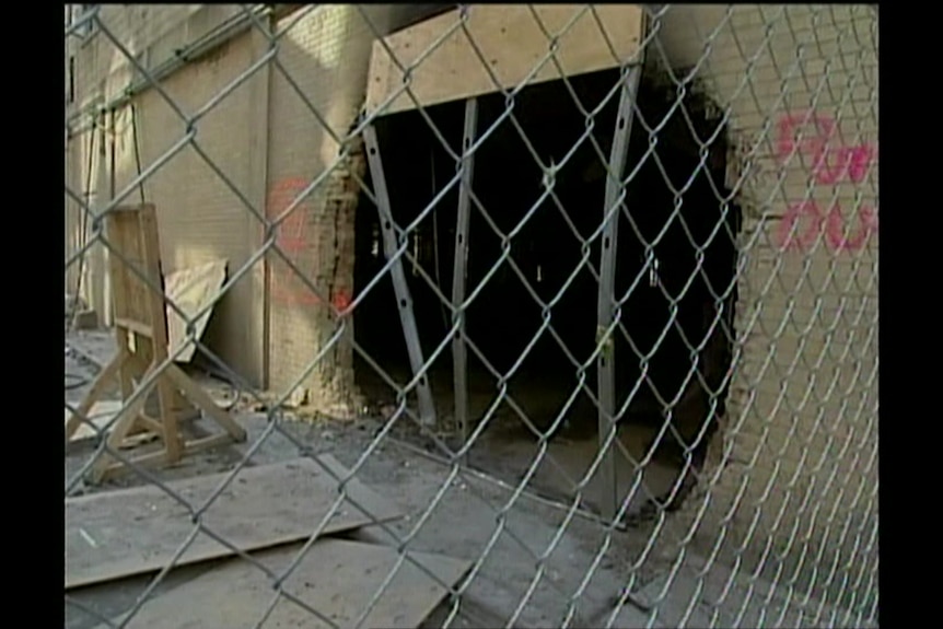 Large hole in side of a building.