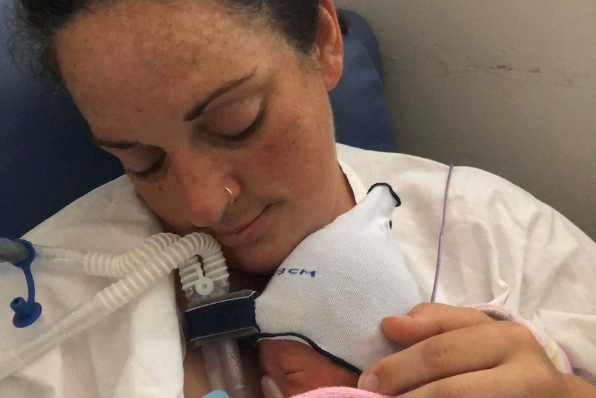 Abbey Leggett holds her newborn baby.