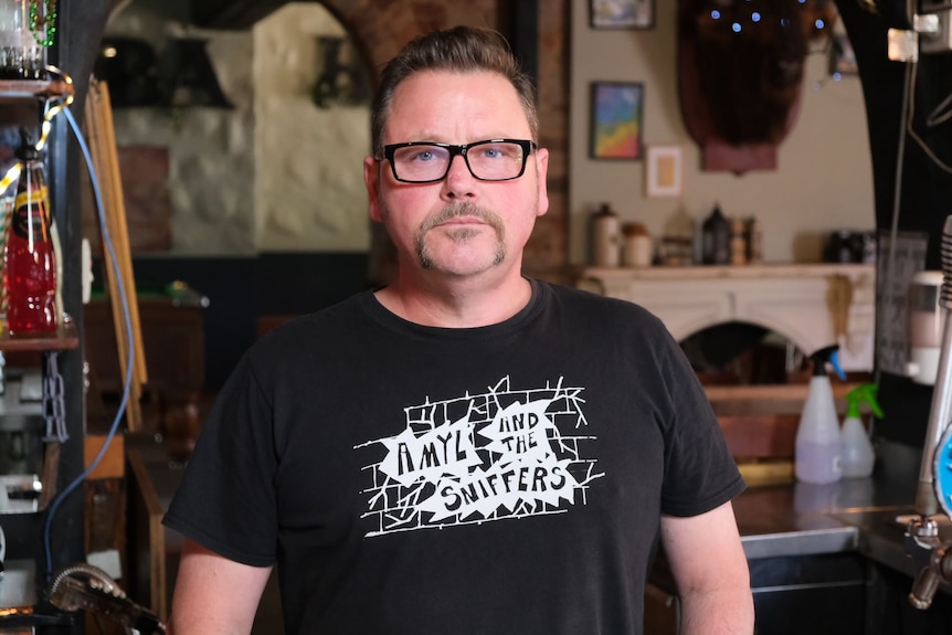 Stuart Gaunt stands inside his West Melbourne bar