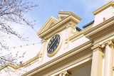 A close up of a clock on top of a building
