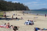 Beach goers at Tasmania's Kingston beach as summer temperatures reach the early 30s.